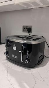 a black toaster sitting on top of a counter at Filton 6 BDR House for contractors & families. in Bristol