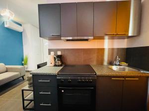 a kitchen with a sink and a counter top at Casa d' arte in Corfu Town