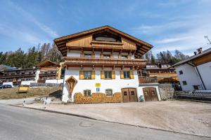 a large house with a wooden roof at Manuel's Alpenrose in Sesto
