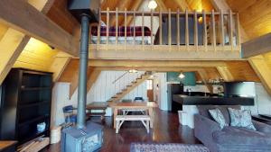 a living room with a loft with a staircase at Elk Run A-frame House With Hot Tub And High Speed Wifi in Red River