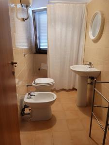 a bathroom with a toilet and a sink at Villa S.Antonio in Ascea