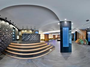 a lobby with a spiral staircase in a building at Hotel Condor Tulcea in Tulcea