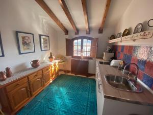 a kitchen with a green rug on the floor at La Reposada in Ardales