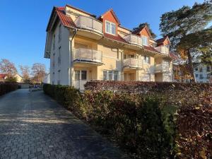 a large building with a fence in front of it at K8 FeWo - Am Kurpark - Therme in Bad Saarow