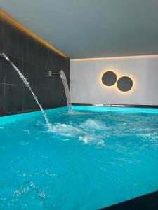 a pool with a water fountain in a room at Monte Hotel in Gudauri