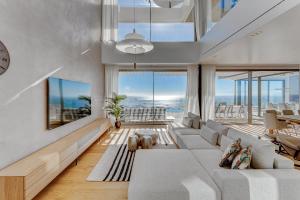 a living room with a couch and a tv at Serenity Heights - Luxury Concierge Service by Olax Rentals in Adeje