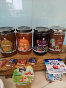 a group of jars of food sitting on a counter at Kyriad Direct Arras - Saint-Laurent-Blangy - Parc Expo in Saint-Laurent-Blangy