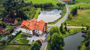 an aerial view of a large house with a lake at Apartamenty Sun & Snow Bawaria II in Szklarska Poręba