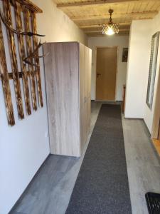 a hallway with a door and a hallway at Apartman Regina in Sunger +6 photos