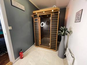 a room with a mirror and a vase on the floor at Stavanger Bnb billiard Sauna in Stavanger