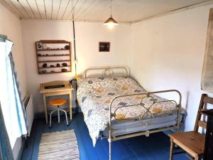a small bedroom with a bed and a table at Traditional Countryside Farmhouse in Reenconnell