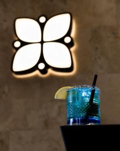 a drink with a lemon slice in a glass at Emery Hotel in Pristina