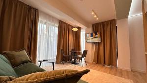 a living room with a couch and a table at Cubrio Apartments in Iaşi