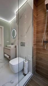 a bathroom with a shower and a toilet and a sink at Cubrio Apartments in Iaşi