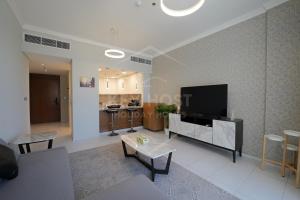 a living room with a flat screen tv on a wall at KeyHost - Classy 2BR Apartment near to Five Hotel - JVC - K550 in Dubai