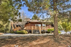 a large wooden house with a large deck at Cozy Grand Woodland Cabin with Mountain Views in Pine Mountain Club