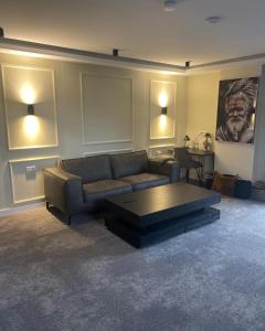 a living room with a couch and a coffee table at 3 Monkeys Hotel in Steinfurt