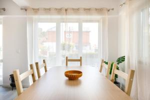 a dining room with a wooden table and chairs at Villas Boas House Caparica in Costa da Caparica +15 photos
