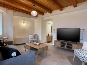 a living room with a large flat screen tv at La Casa Di Manou in Platanias