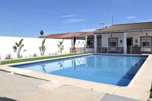 a swimming pool in front of a house at La Orquídea de Córdoba in Córdoba