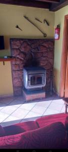 a microwave oven sitting on top of a brick fireplace at La casina de castiello in Arriondas