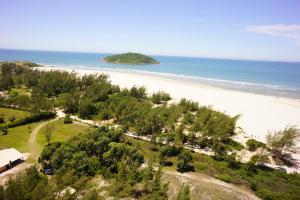 an aerial view of a beach with an island at Pousada Natural Park in Imbituba