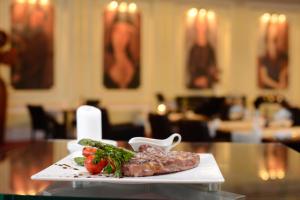 a plate of meat and vegetables on a table at Grand Hotel Bucharest in Bucharest