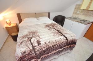 a bedroom with a bed with a blanket with trees on it at Old town central in Kotor +17 photos