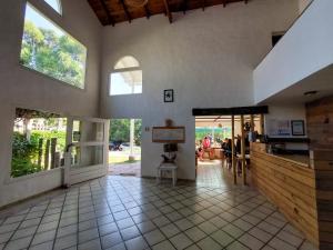 a large room with a kitchen and a dining room at África Posada in Pinamar