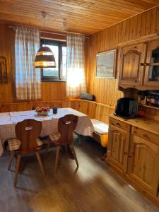 a kitchen with a table and chairs in a room at La Piccola Galleria in Lottigna