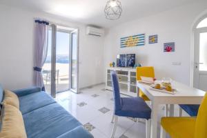 a living room with a blue couch and a table at My home Capri in Capri