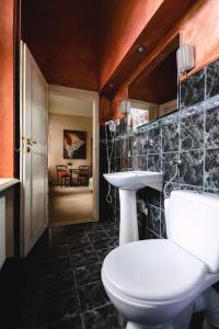 a bathroom with a white toilet and a sink at Dwór Podstolice - House of Rosenthal in Podstolice