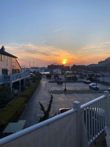 a view of a parking lot with the sunset in the background at monthly only shared apt in Newport