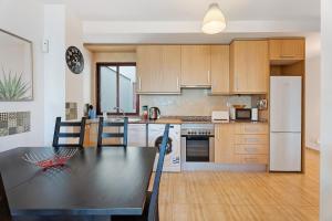 a kitchen with a table and a refrigerator at Apartamento Tazacorte in Tazacorte