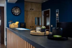 a counter in a room with a clock on the wall at Hotel Mountime in Täsch