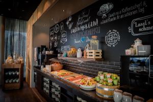 a restaurant with a counter with food on it at Motel One Innsbruck in Innsbruck
