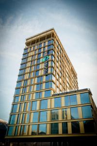 a tall building with a sign on top of it at Motel One Innsbruck in Innsbruck