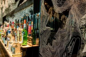 a display of bottles of alcohol on a shelf at Motel One Innsbruck in Innsbruck