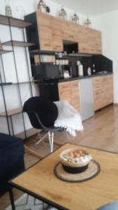 a room with a table with a bowl of food on it at Apartament w Pieninach in Krościenko