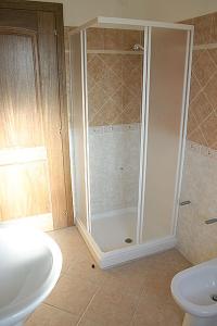 a bathroom with a shower and a toilet and a sink at Acquadolce in San Teodoro