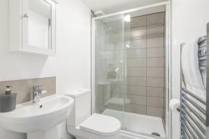 a bathroom with a toilet sink and a shower at Cambridge - Private Room 8 by Milton Guest House in Cambridge