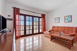 Vivienda Vacacional Timarasan في Lodero: غرفة معيشة بها أريكة وطاولة