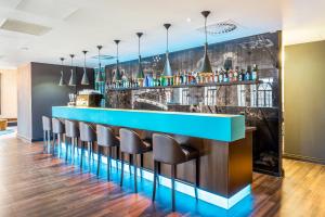 a bar with chairs and a blue counter at Motel One Edinburgh-Princes in Edinburgh