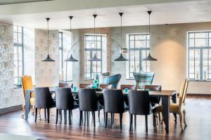 a dining room with a table and chairs at Motel One Edinburgh-Princes in Edinburgh