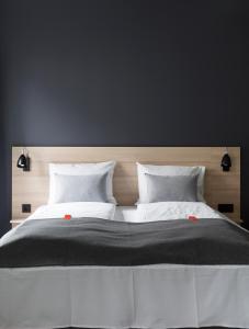 a large bed with two white pillows on it at Citybox Bergen City in Bergen