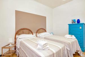 a bedroom with two beds and a blue dresser at Il Verde nel Blu in Monterosso al Mare