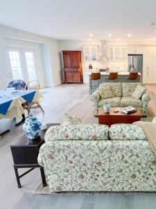 a living room with a couch and a table at Ned's Landing at Spry Point in Little Pond