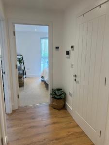 a hallway with a door leading to a bedroom at 45 Teesra House in Plymouth