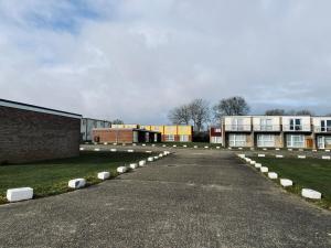 an empty parking lot in front of a building at Cosy and Comfortable Holiday Chalet 10 minutes walk to the beach, Norfolk in Great Yarmouth