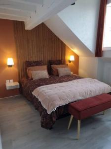 ein Schlafzimmer mit einem großen Bett und einer roten Bank in der Unterkunft Appart'Hôtel Blois vue Château in Blois